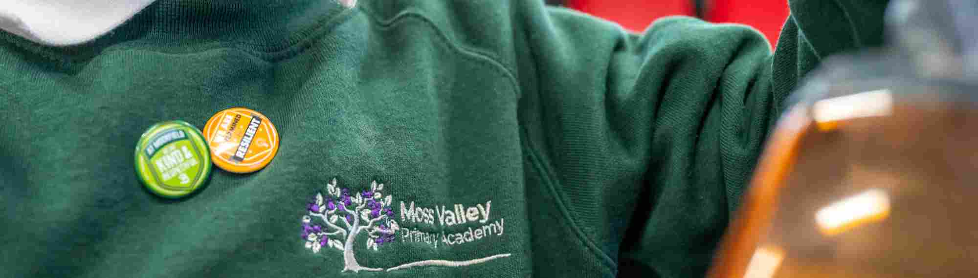 Moss Valley school jumper close up with achievement badges